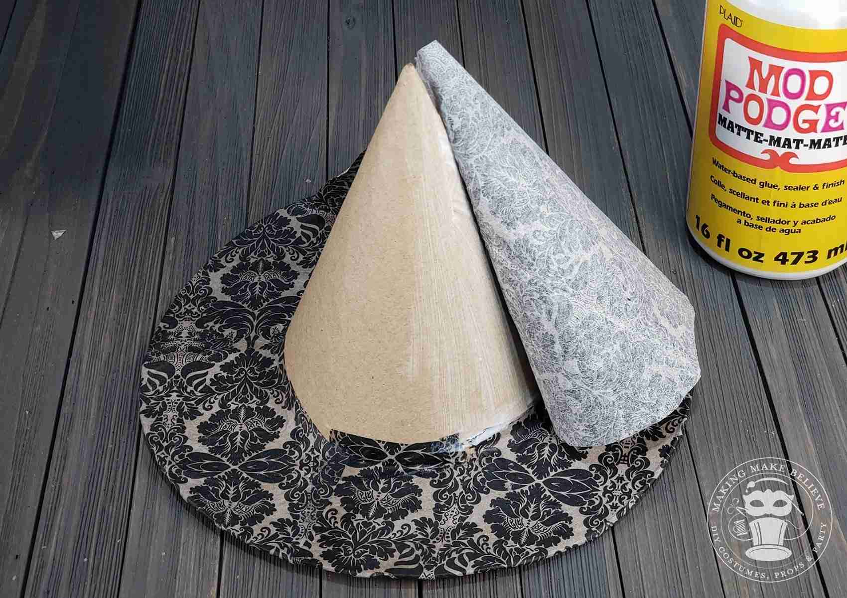 Attach napkin to cone portion of hat