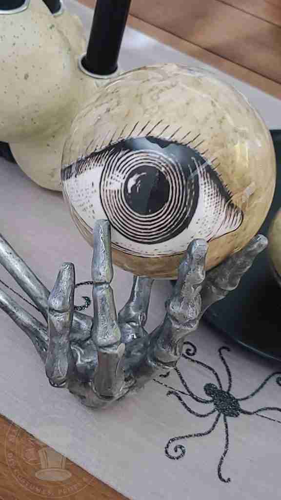 Tablescape eyeball and silver skeleton arm