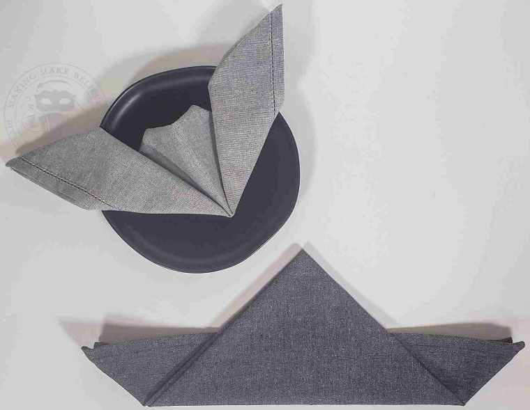 Fold point of triangle upward over straight edge