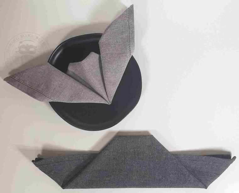 Fold tip of triangle under