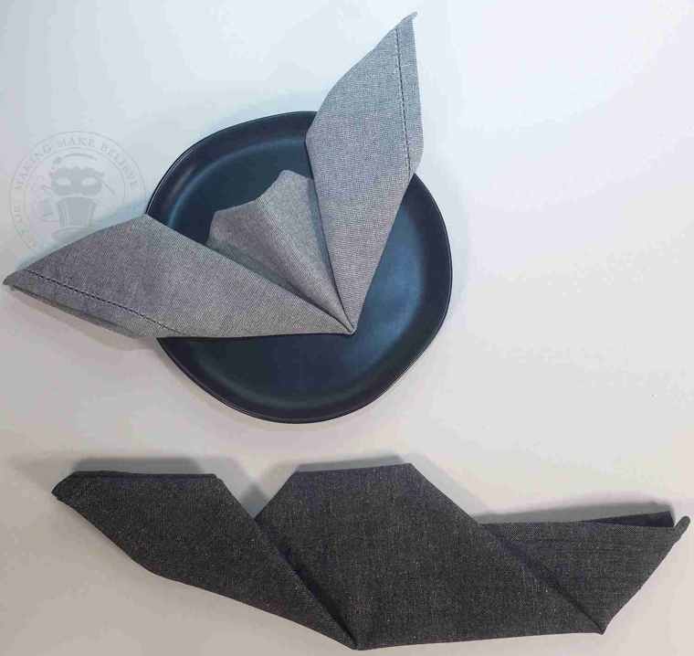 Fold up left side of napkin at an angle to form bat wing
