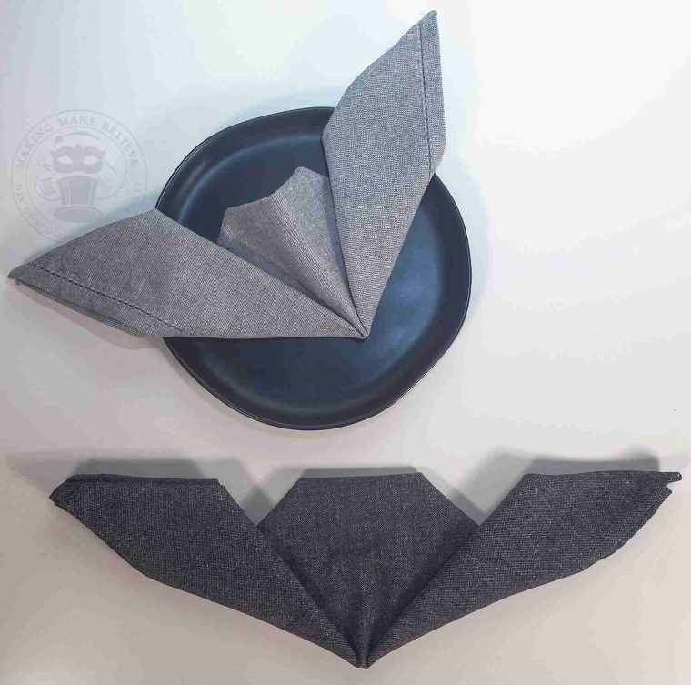 Fold up right side of napkin at an angle to form second bat wing