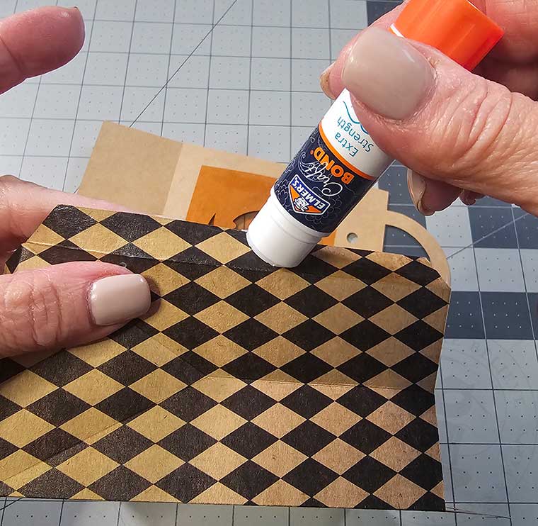Glue sides tabs on sides of Halloween treat sack