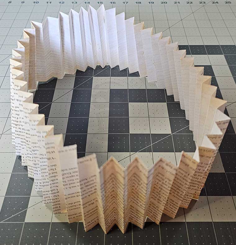 Stand pages up with text facing downward