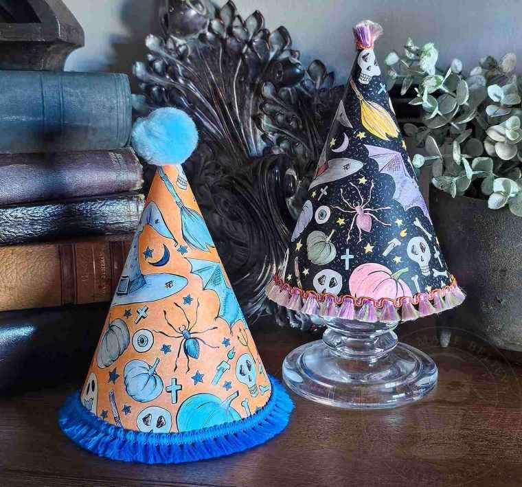 Hand-colored Halloween party hats trimmed and decorated