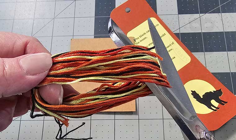 Remove floss from board and cut bottom of loop