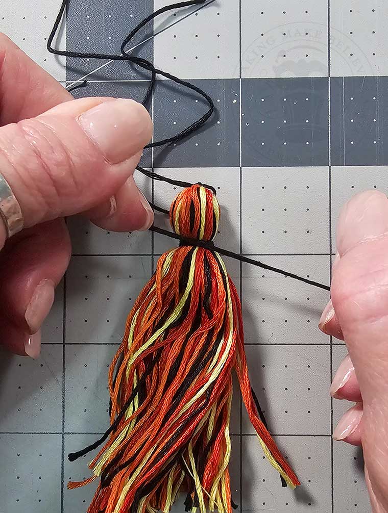 Tie off the top of the tassel