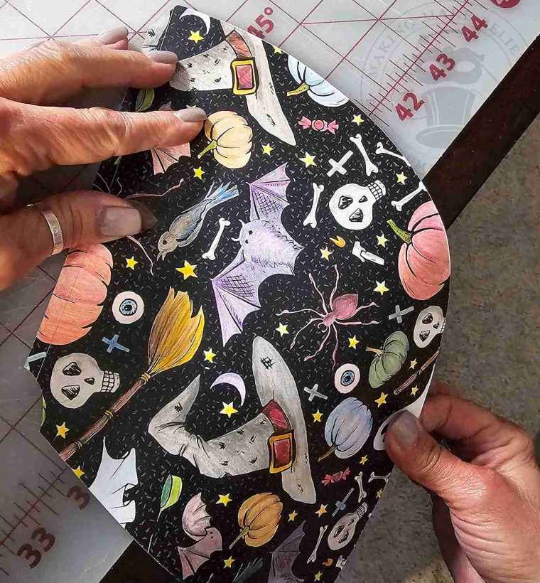 Roll hat along edge of table to gently curl into shape