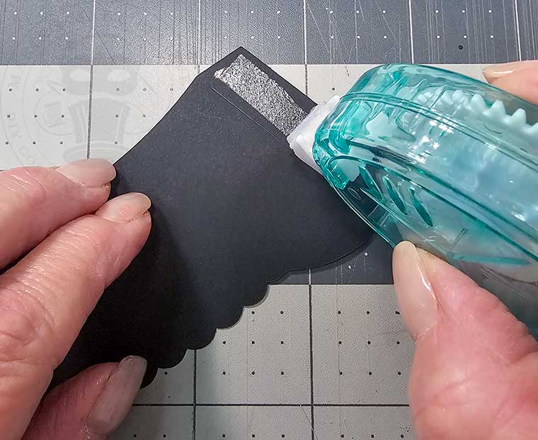 Add adhesive to score line side of cupcake wrapper