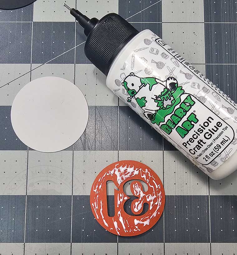 Glue together Halloween cupcake wrapper medallions
