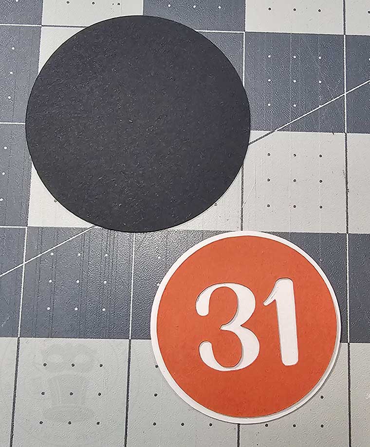 Glue together Halloween cupcake wrapper medallion