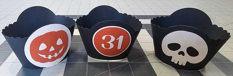 Glue Halloween medallions onto cupcake wrappers