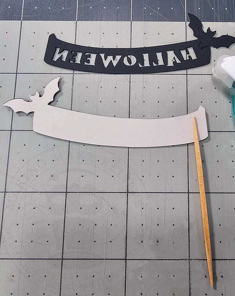 Add toothpick and backing to Halloween cupcake pick banner