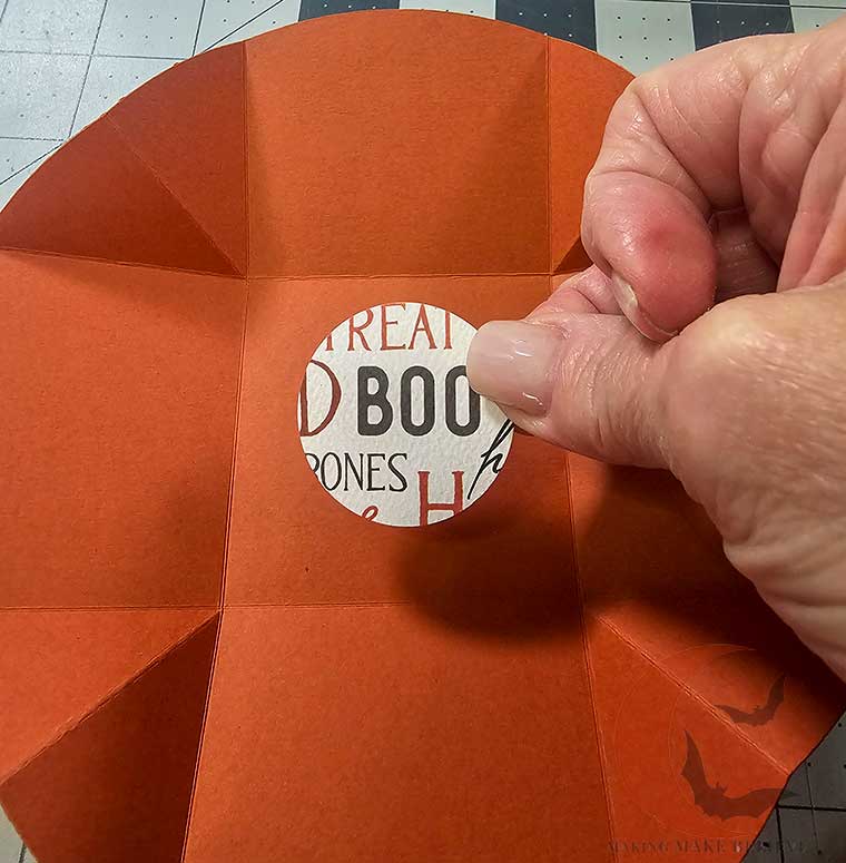 Add square or embellishment to center of Surprise Treat Box base