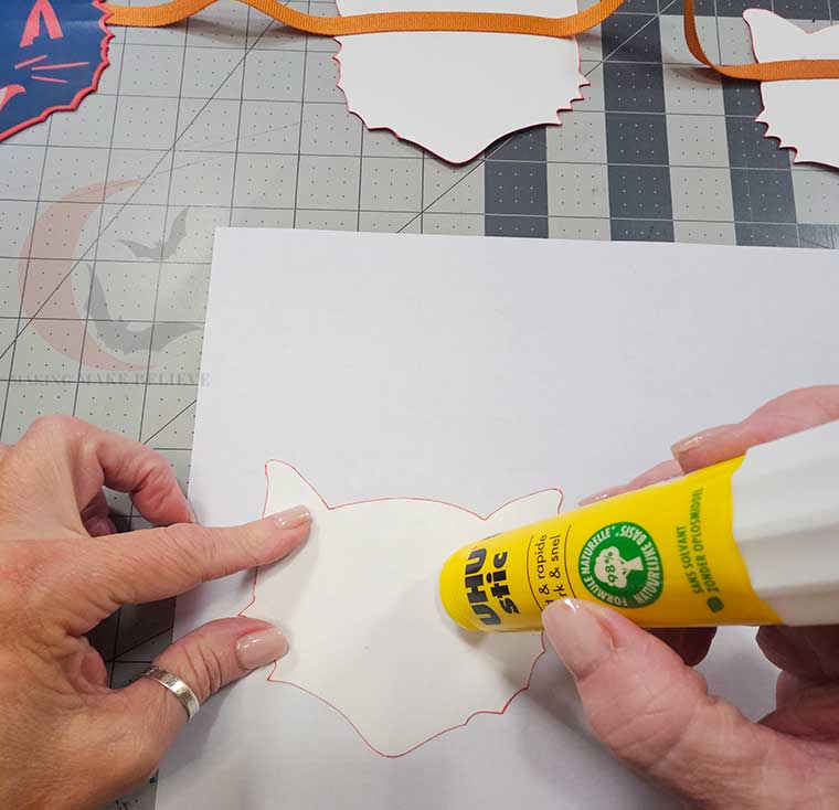 Add glue to back of cat face