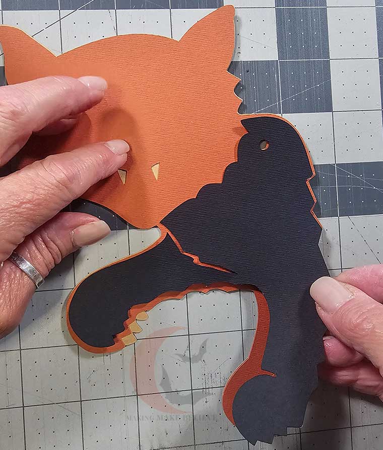 Glue black front section paws onto orange layer
