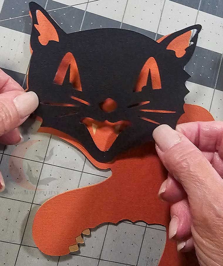 Glue black cat face into pllace