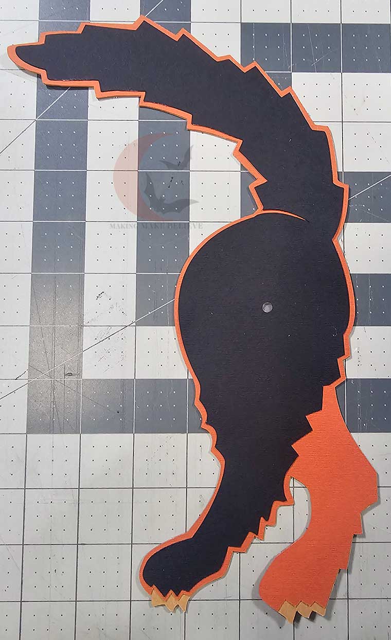Glue orange back section onto taupe layer and top off with black layer