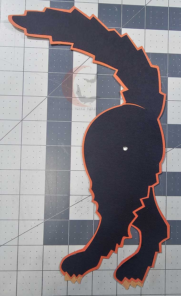 Glue black paw piece into place