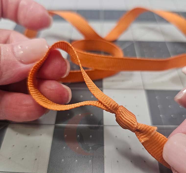 Form a loop hanger at the end of the ribbon
