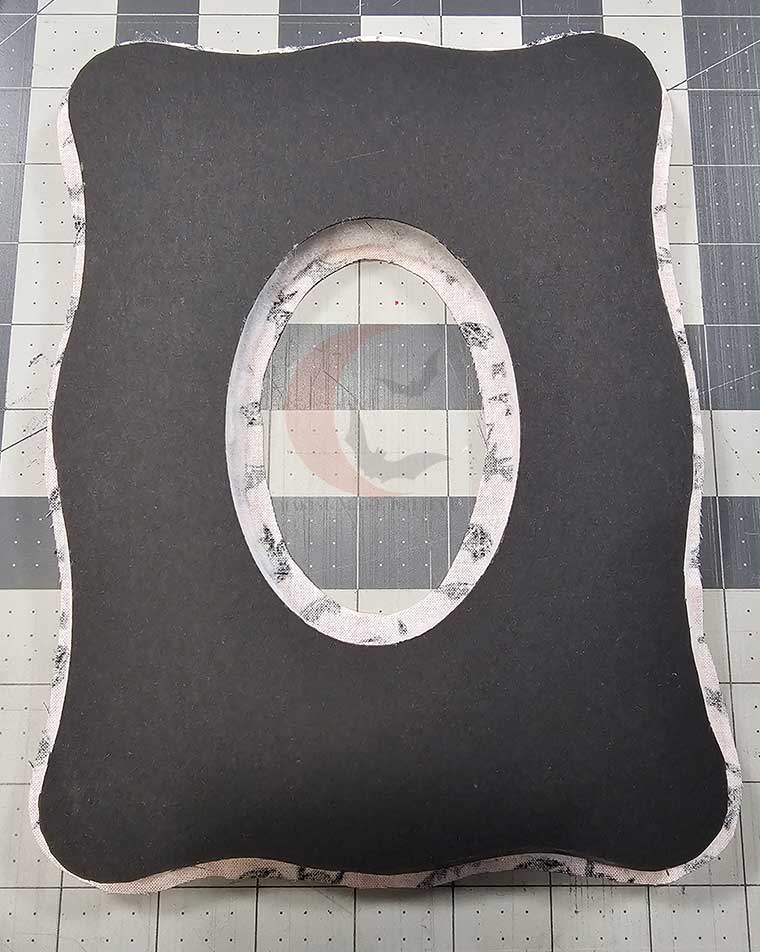 Lay cardstock and batting onto fabric