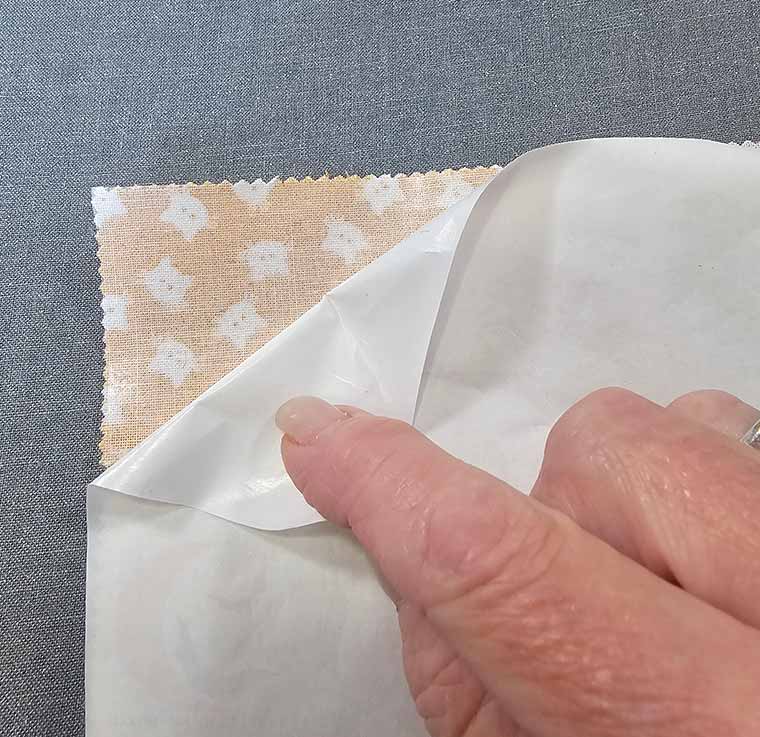 Remove paper backing from Wonder Under
