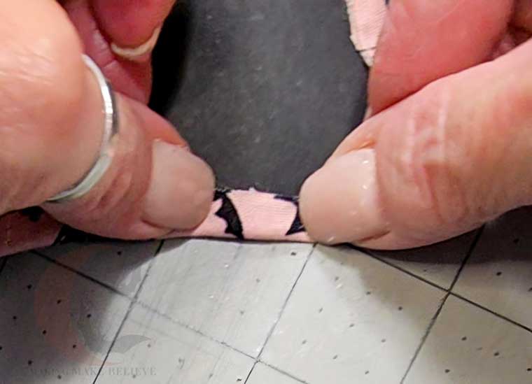 Fold fabric to back to secure
