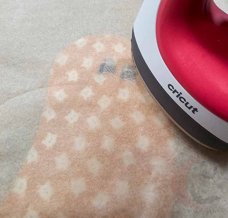 Top fabric pieces with parchment and iron to fuse